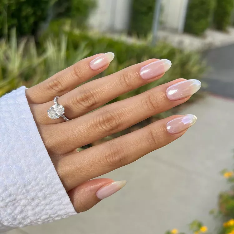 Inspired by Hailey Bieber’s iconic look, glazed donut nails feature OPI's Funny Bunny Nail Polish and Tin Man Can Chrome Powder for a glossy, chic finish.