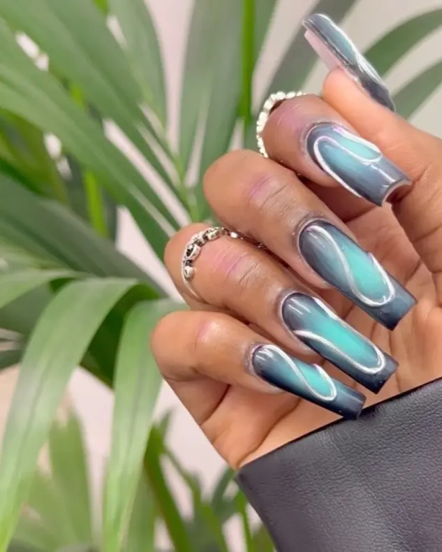 Black and turquoise chrome aura nails
