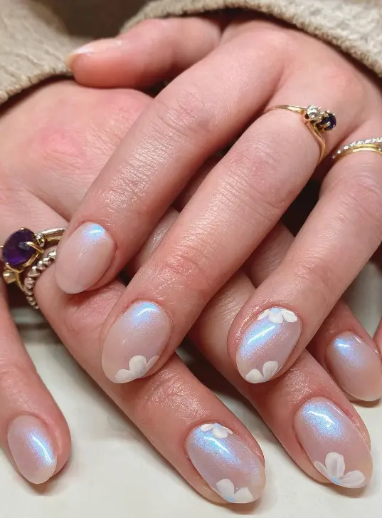 Nude chrome iridescent nails with white flowers