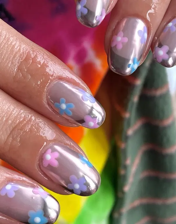 Chrome nails with pink and purple tiny flowers
