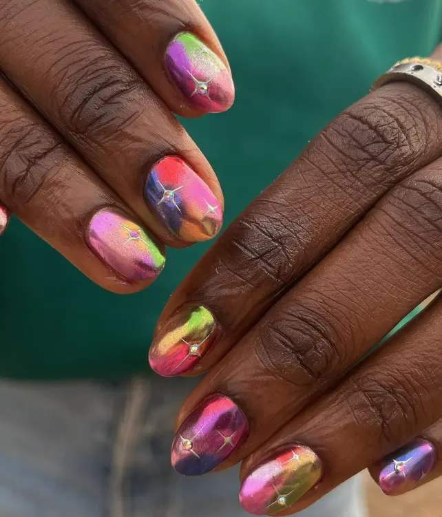 Colorful chrome opulent nails with tiny stars
