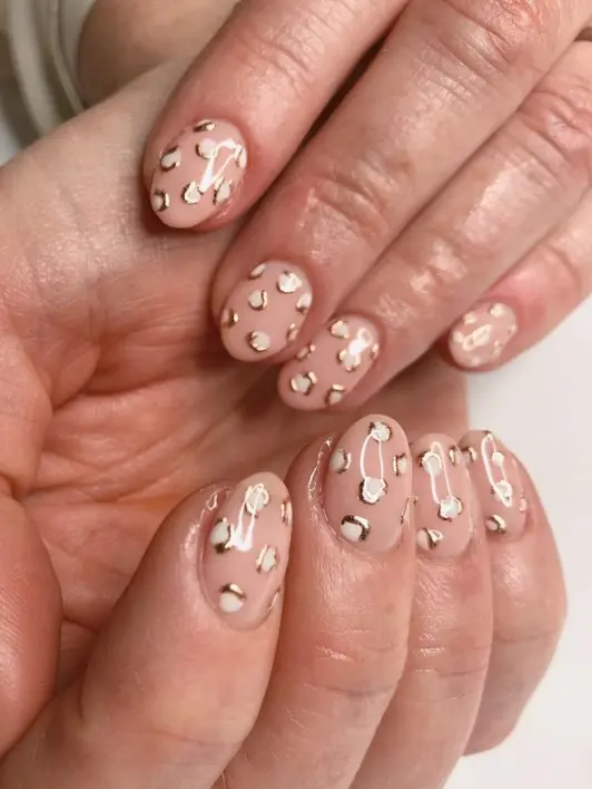 Nude nails with white and gold foil leopard print
