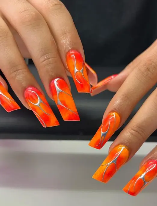 Shades of orange lipstick nails with silver chrome
