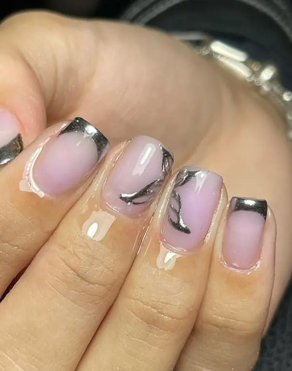 Nude pink nails with chrome silver butterflies and French tips
